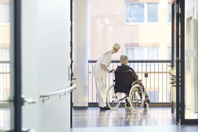 Foto einer Patientin im Rollstuhl im Krankenhaus als Symbol für die Notwendigkeit einer Vorsorgevollmacht auch ohne Notar